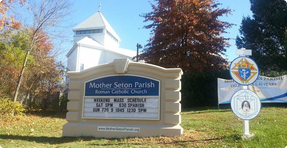 Sign of Mother Seton Parish with Church behind it.
